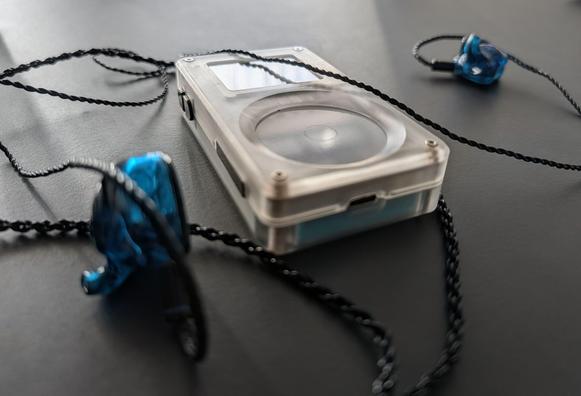 Tangara flac player on a desk with IEMs attached.