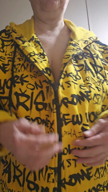 Me doing sexy striptease dance.
I'm wearing yellow cotton jacket.
With Black Letters naming many;
Cities across international world;
I then slowly unzip yellow jacket;
I sensuously caress my breasts;
As I sensuously dance around;
PIc cropped from chin to midriff.